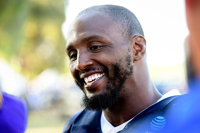 Dallas Cowboys defensive end Robert Quinn talks with reporters at the team's training camp July 29 in Oxnard, Calif. Quinn is set for his Dallas debut against Miami after the Dolphins traded the defensive end to the Cowboys in the offseason. He served a two-game suspension. (AP Photo/Michael Owen Baker)