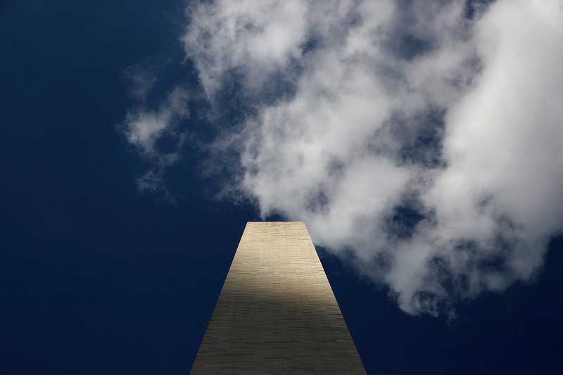 Clouds roll over the Washington Monument on Wednesday, as seen from the foot of the monument, during a press preview tour ahead of its official reopening in Washington. The monument, which has been closed to the public since August 2016, is scheduled to reopen today.