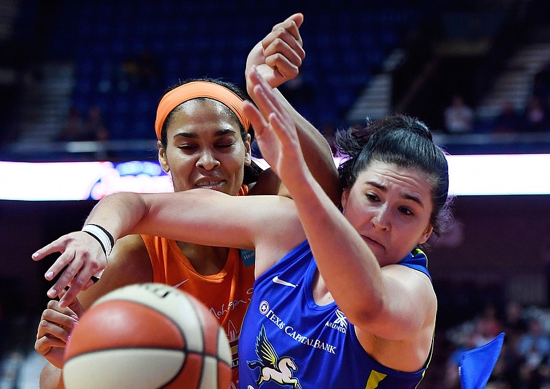 FILE - In this Sept. 4, 2019, file photo, Connecticut Sun center Brionna Jones, left, and Dallas Wings forward Megan Gustafson tangle while going for a rebound during a WNBA basketball game in Uncasville, Conn. Gustafson recently finished her rookie season in the WNBA, and is off to Hungary for pro basketball in the winter.  (Sean D. Elliot/The Day via AP, File)