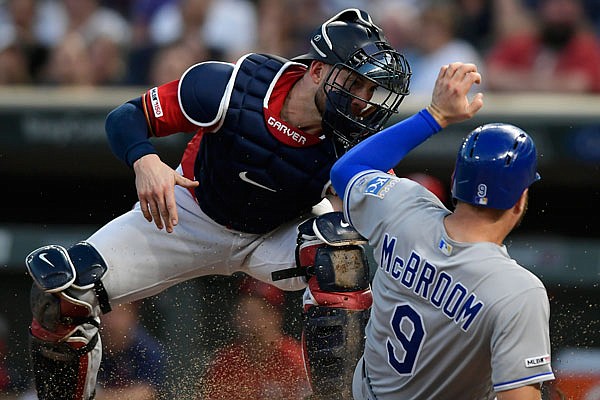 Ryan McBroom of the Royals is tagged out at home by Twins catcher Mitch Garver during the second inning of Thursday night's game in Minneapolis,