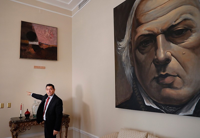  Carlos Vecchio, an exiled politician who the U.S. recognizes as Venezuela's ambassador, points to a blank section of a wall on Tuesday where artwork once hung inside the ambassador's residence in Washington. U.S. officials are investigating the possible looting from Venezuela of valuable European and Latin American artwork they believe is being quietly plundered by government insiders as Nicolas Maduro struggles to keep a grip on power. 