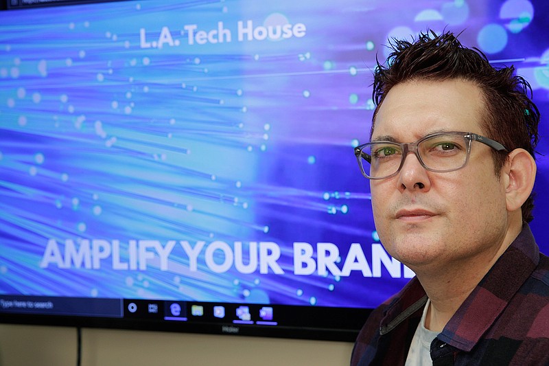 In this Tuesday, Sept. 17, 2019 photo, Gabe Uribe, co-owner of L.A. Tech House, a public relations firm that focuses on tech companies, poses in his office in Beverly Hills, Calif. When he began advertising online, he went with the common wisdom that the more spent on Google ads, the better the results. But he learned he could cut his budget and be fine. "If you put some strategy into it, you have a good chance of going up against the big guys," Uribe says. "We own our little corner with tech PR." (AP Photo/Damian Dovarganes)