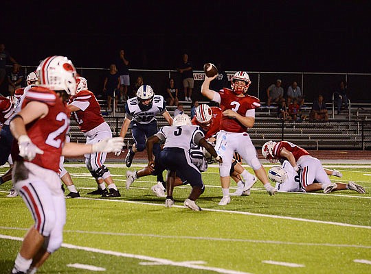 Jays quarterback Cole Gresham throws a pass during Friday night's game against St. Louis University High at Adkins Stadium.