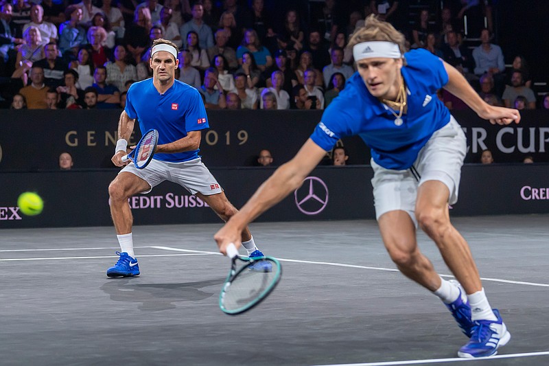 Team Europe's Roger Federer, left, and Alexander Zverev play against Team World's Denis Shapovalov and Jack Sock at the Laver Cup tennis event, in Geneva, Switzerland, Friday, Sept. 20, 2019. (Martial Trezzini/Keystone via AP)