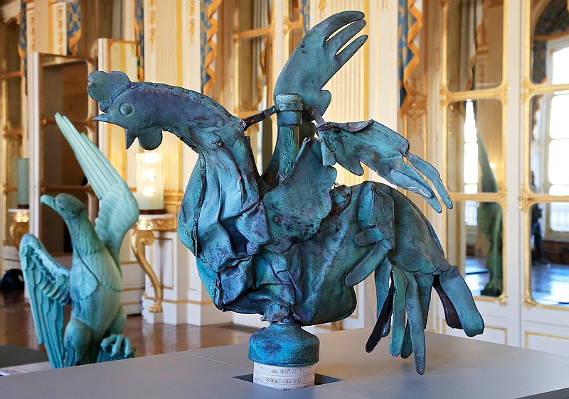 The rooster that plunged to the ground during the fire at Notre Dame Cathedral is displayed Friday at the Culture Ministry in Paris. The rooster, long a symbol of France, tumbled to the ground in the April blaze that consumed the cathedral's roof and collapsed its spire. The bird somehow survived and is going on public display this weekend.