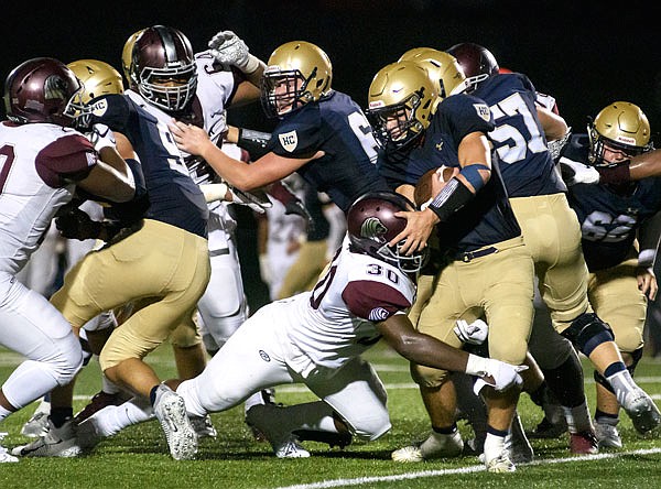 Helias' Thomas Bruemmer fights to pick up yardage during Saturday night's Homecoming game against Cardinal Ritter at the Crusader Athletic Complex.