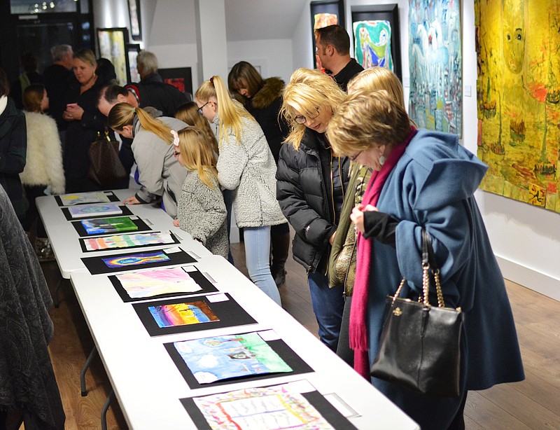 <p>News Tribune file</p><p><strong>Guests look through submissions to a school art contest in February at the Jefferson City Museum of Modern Art. The museum’s annual high school art contest will be next month.</strong></p>