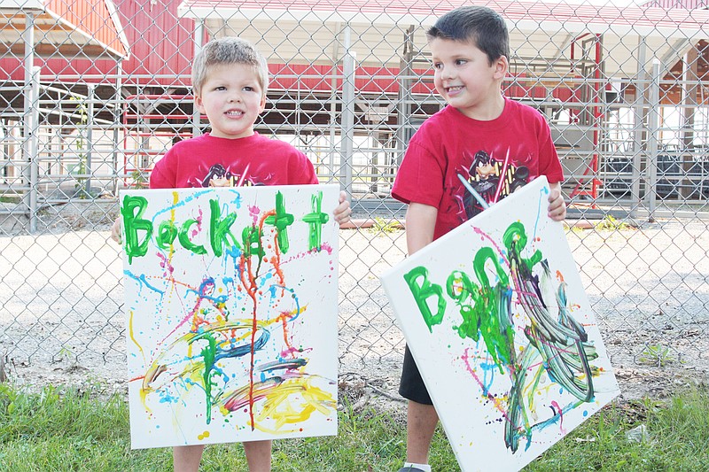 From left, Becket Crawford, 3, and Bane Crawford, 4, created abstract masterpieces at the 2016 Ashley Garret Memorial Children's Art Festival.