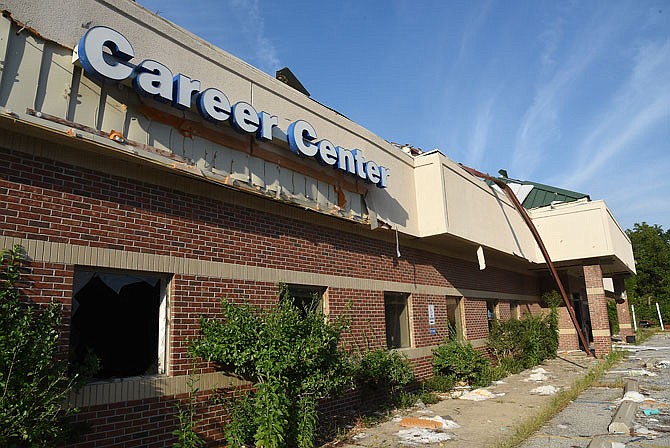 The building that formerly housed the Missouri Career Center on Four Seasons Drive remains empty and the parking lot littered with debris after the May 22 tornado heavily damaged the building.