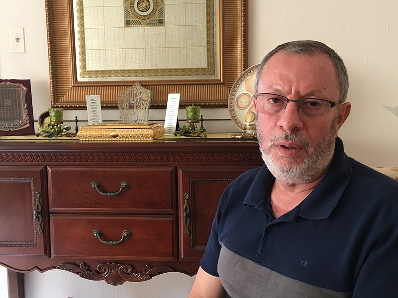 Abdelhaleem Ashqar sits in his Springfield, Va., home, Thursday, Sept. 12, 2019, discussing his deportation case. The U.S. government tried to deport him via Israel earlier this year, but a judge’s order forced the U.S. to reverse course on a Tel Aviv tarmac and bring the Palestinian activist back to Virginia while his case gets sorted out. (AP Photo/Matthew Barakat