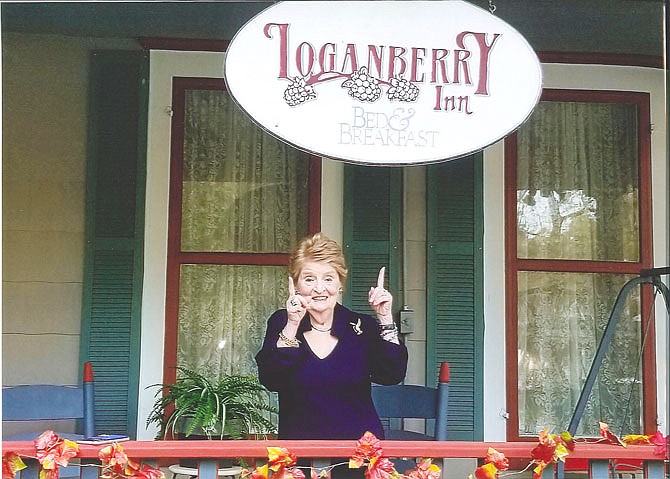 Former U.S. Secretary of State Madeleine Albright grins under the sign for the Loganberry Inn, which hosted her during her recent visit to Fulton. It's far from the first time the bed and breakfast has been a temporary home to famous guests.