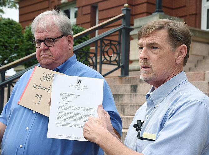 David Clohessy, near, and Tom White held a press conference on the steps outside the attorney general's office Wednesday to talk about the results of Attorney General Eric Schmitt's recently-released report. Clohessy is former executive director of Survivor's Network of those Abused by Priests and is asking Schmitt to further investigate the matter and request authority to subpoena witnesses. White is a former Catholic priest who found out three men with whom he attended seminary were later accused of abuse, with one of those being defrocked.