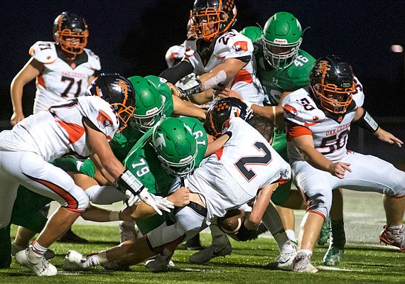 Blair Oaks defensive lineman Rylee Niekamp (79) lays a hit on Oak Grove running back Brenden Marsh during a game earlier this month at the Falcon Athletic Complex in Wardsville.