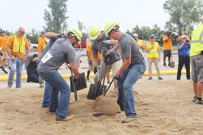 Levi Mealy, center, and his teammates compete in the hand-dig competition, one of four qualifying events at the National Gas Rodeo. Out of nearly 60 teams, the Troubadours, from Mid-Missouri, placed 18th.