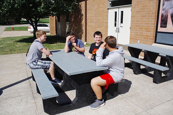 New Bloomfield High School students Nathan Mueller, Ethan Hake, James Wilson and Michael Leason enjoy the district's new majority recycled tire tables the district purchased with its $12,000 grant from the Missouri Department of Natural Resources. The district purchased 23 tables and benches with the grant money.
