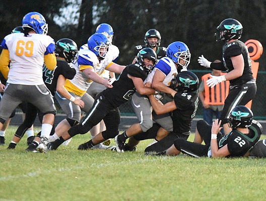 North Callaway defensive end Ben Bondurant (54) and linebacker Christian Griffith (25) team up to take down Wright City running back Branden Contreras during the Thunderbirds' 14-6 Eastern Missouri Conference loss to the Wildcats last Friday in Kingdom City.