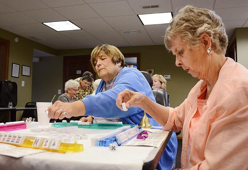 Pat Wojciehowski, left, makes a play as Nancy Epple concentrates on her sequence of tiles Tuesday Sept. 17, 2019, as they compete in a game of mahjong at West Point Senior Center in Jefferson City. This was the third game Wojciehowski has organized since establishing an official mahjong club in August. 