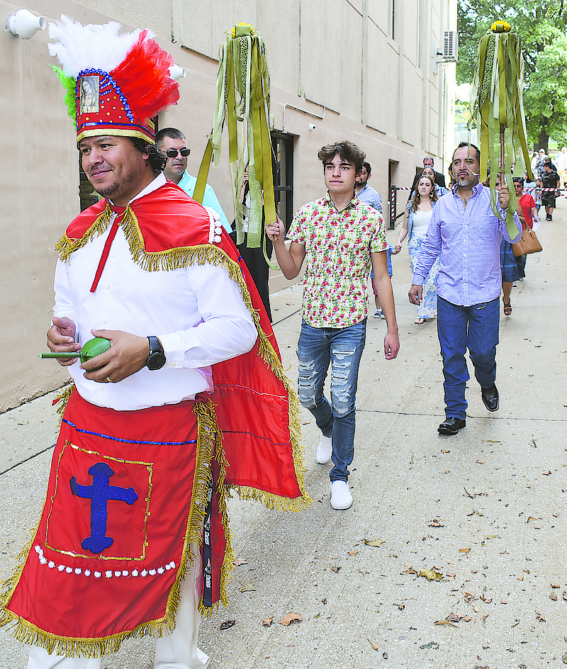 Jefferson City resident Hector Guillen performs a matachines dance as he leads the way to a reception for the 20th anniversary celebration for Hispanic ministry El Puente.