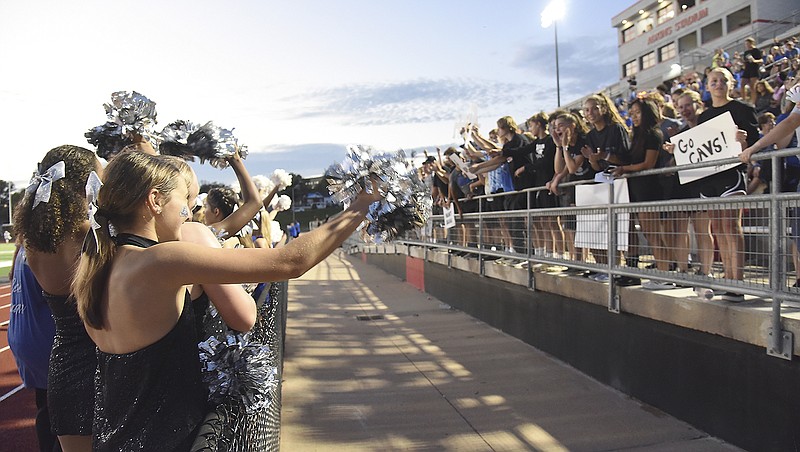 Capital City High School cheerleaders greeted schoolmates as they took to the track prior to Monday night's homecoming football game at Adkins Stadium. The Cavaliers took on the Battle Spartans in freshman and junior varsity games.