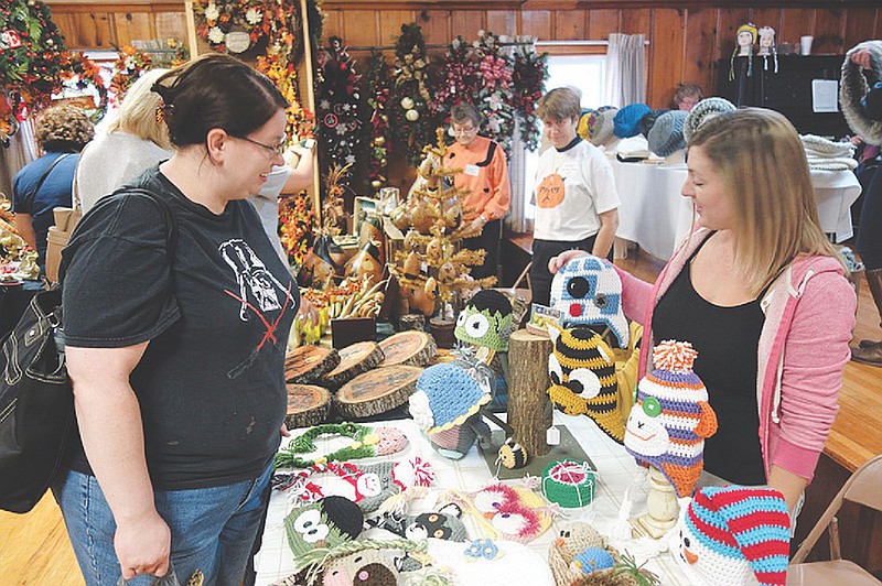 <p style="text-align:right;">File photo</p><p><strong>Allie Talley, left, asks Ashley Leakey about her custom crocheted hat made to look like the droid R2D2 from “Star Wars” at a previous craft show in Hatton.</strong></p>