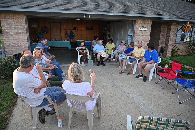 Texarkana, Ark., residents gather around and socialize at Danny and Vicky Land's home for National Night Out on Tuesday in Texarkana, Ark. Across the nation, police departments encourage the community to gather and stand up against crime in their area.