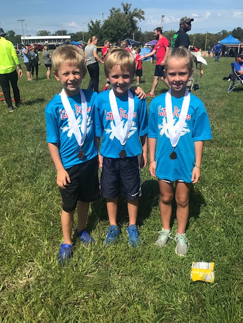 Carson Lebel, Bralynn Porter, and Moses Bestgen all medaled in the six-eight age group for the Little Pintos in their meet in Paris Sept. 14, 2019.  (Photo courtesy of Danielle Lebel)