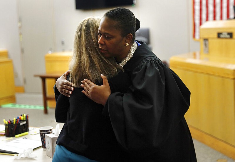 State District Judge Tammy Kemp gives former Dallas Police Officer Amber Guyger a hug before Guyger leaves for jail, Wednesday, Oct. 2, 2019, in Dallas. Guyger, who said she mistook neighbor Botham Jean's apartment for her own and fatally shot him in his living room, was sentenced to a decade in prison. (Tom Fox/The Dallas Morning News via AP, Pool)