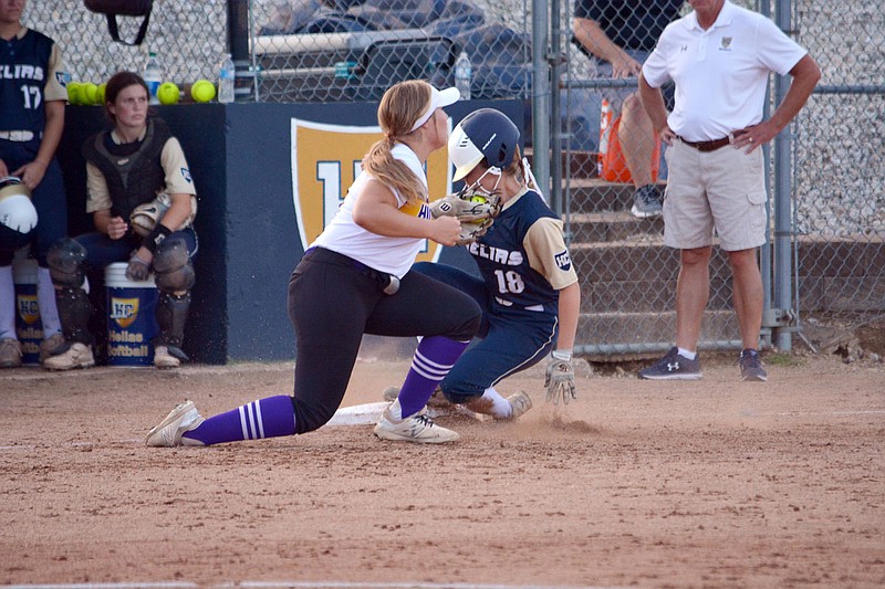 Taylor Woehr of Helias slides into third base before getting tagged by Hickman's Athena Wheeler during Wednesday's game at the American Legion Post 5 Sports Complex. 