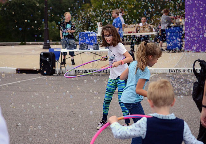 Ava McKinney, 9, joins in a Hula Hoop activity Thursday during the United Way of Central Missouri Kids United FunFest at the Boys & Girls Club of Jefferson City. United Way and several of their partner agencies provided the carnival so local families could enjoy a night out. 
