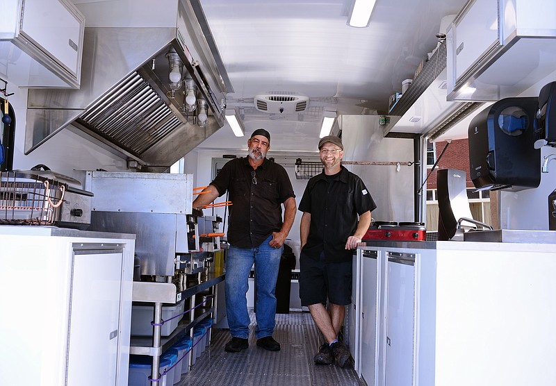 Sally Ince/ News Tribune 
Owners John Johnson, left, and Quinten Rice stand inside their new food truck Friday October 4, 2019 as it's parked beside their JQ's on High restaurant. The pair will be serving some of their menu items plus some specialty items during the Honor Flight Charity Golf Tournament this Wednesday at Tanglewood Golf Course in Fulton. 