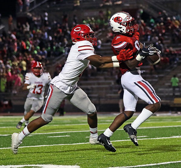 Jefferson City receiver Devin White catches a pass in front of Chaminade's Cam Epps during last Friday night's Homecoming game at Adkins Stadium.