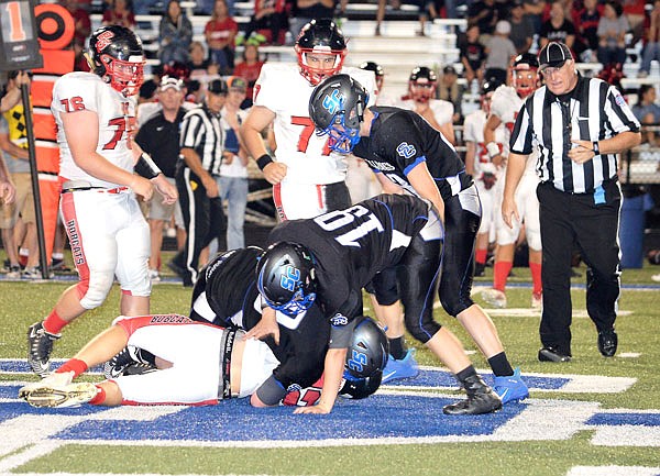 A trio of South Callaway defenders secure a Bowling Green ball carrier on the ground during the Bulldogs' 20-10 Eastern Missouri Conference loss to the Bobcats last Friday in Mokane.