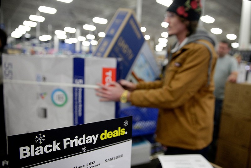 In this Nov. 22, 2018, file photo people wait in line to buy televisions as they shop during an early Black Friday sale at a Best Buy store on Thanksgiving Day in Overland Park, Kan. The National Retail Federation, the nation's largest retail trade group, announced on Thursday, Oct. 3, 2019, that it is forecasting that holiday sales will rise between 3.8% and 4.2% even as uncertainty looms over an escalating trade war with China (AP Photo/Charlie Riedel, File)