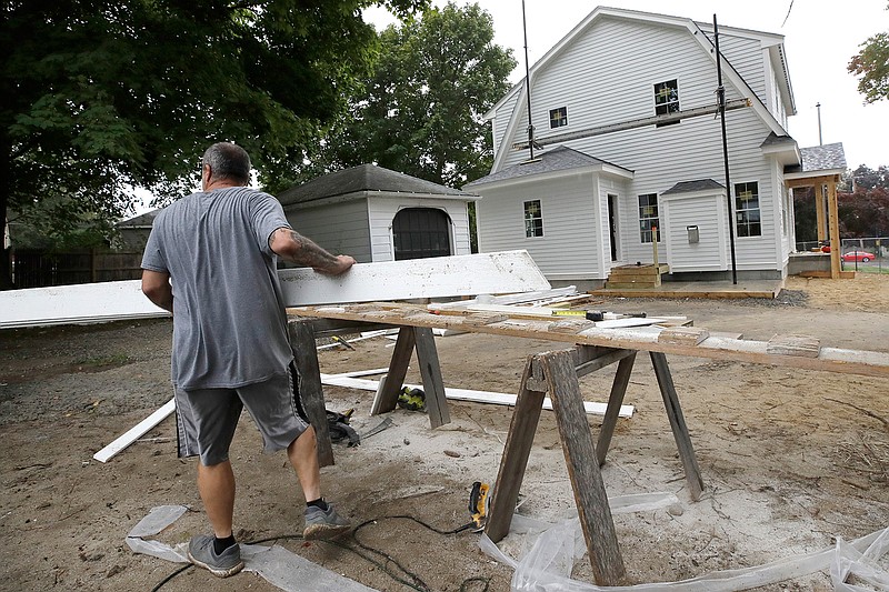 In this Wednesday, Oct. 2, 2019, photo, a carpenter works on a construction site in North Andover, Mass. On Thursday, Oct. 3, the Institute for Supply Management, a trade group of purchasing managers, issues its index of non-manufacturing activity for September. (AP Photo/Elise Amendola)