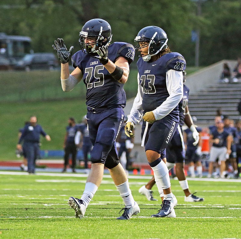 Lincoln linebackers Dawson Brandt (left) and JaJuan Chambers celebrate after a sack during last Saturday's game against Emporia State at Dwight T. Reed Stadium.