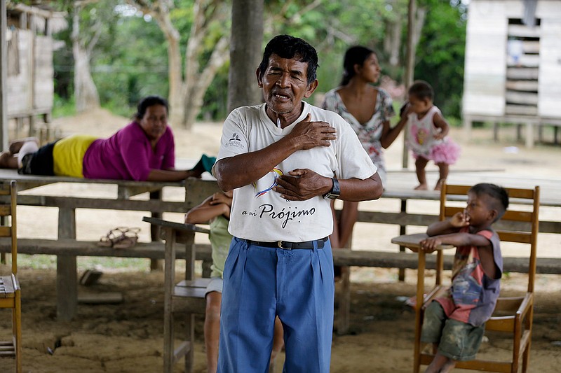 Antelmo Pereira leads a religious class in the indigenous Tikuna village of Santa Rosa, Brazil, Saturday, Sept. 21, 2019. Pereira, 61, has been a part-time missionary for the past 15 years, volunteering his time on weekends to visit isolated indigenous communities were he teaches and leads prayer ceremonies but cannot perform Mass or hold confession for Catholics. He is married with nine children, and cannot become a priest. (AP Photo/Fernando Vergara)