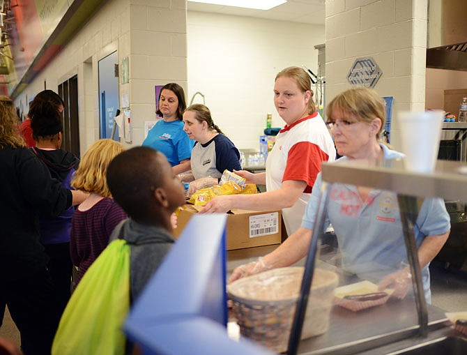 Children wait in line Thursday for meals at the United Way of Central Missouri Kitchen at the Boys & Girls Club of Jefferson City. A 2019 report shows the number of children living in "concentrated poverty" has declined slightly in Missouri. 
