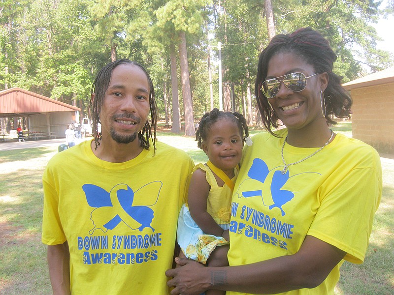 Samuel Ramsire, left, and his wife Ebony, right, hold their two-year-old daughter Essence at the third annual Down Syndrome Awareness Walk Saturday in Spring Lake Park. Essence had a team of at least 25 supporters walking on her behalf.