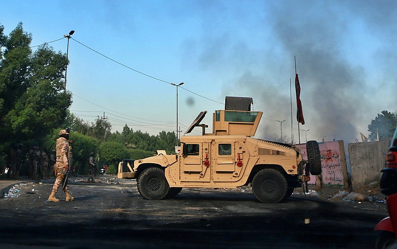 Iraqi Army troops deploy at a site of protests in Baghdad, Iraq, Sunday, Oct. 6, 2019. The spontaneous protests which started Tuesday in Baghdad and southern cities were sparked by endemic corruption and lack of jobs. Security forces responded with a harsh crackdown, with dozens killed. (AP Photo/Khalid Mohammed)