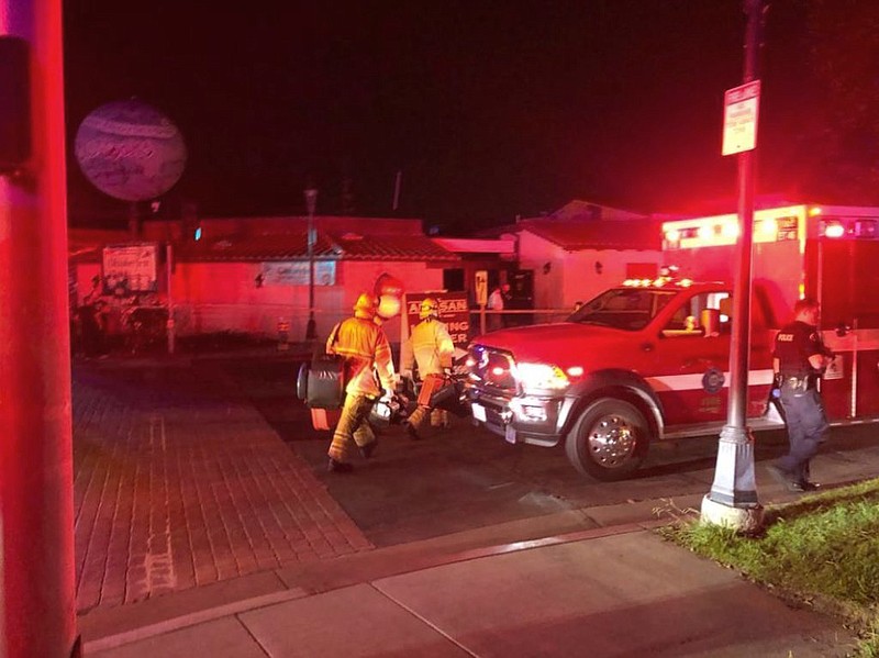 Emergency personnel respond to utility pole explosions where multiple people were injured at the Old World Village on Saturday, Oct. 5, 2019, in Huntington Beach, Calif. "It was just like one giant fireball that went up" Megan Houck, 26, of Long Beach, Calif., said after an explosion occurred at the shopping and dining complex. (Emily Rasmussen/The Orange County Register/SCNG via AP)