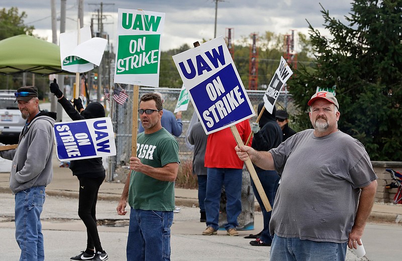 John Kirk, right, a 20-year-employee, pickets with co-workers outside the General Motors Fabrication Division, Friday, Oct. 4, 2019, in Parma, Ohio. (AP Photo/Tony Dejak)