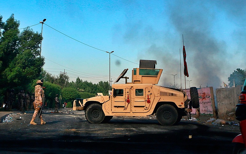 Iraqi Army troops deploy at a site of protests in Baghdad, Iraq, Sunday, Oct. 6, 2019. The spontaneous protests which started Tuesday in Baghdad and southern cities were sparked by endemic corruption and lack of jobs. Security forces responded with a harsh crackdown, with dozens killed. (AP Photo/Khalid Mohammed)