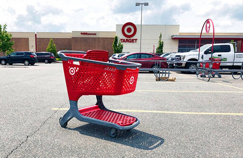 In this June 2019 file photo, a shopping cart sits in the parking lot of a Target store in Marlborough, Massachusetts.