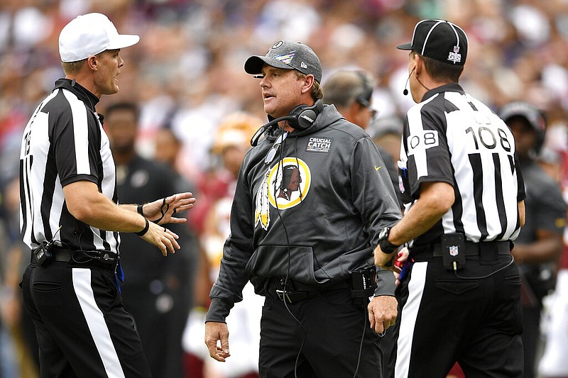 Washington Redskins head coach Jay Gruden speaks to officals during the first half of an NFL football game between the Washington Redskins and the New England Patriots, Sunday, Oct. 6, 2019, in Landover, Md. (AP Photo/Nick Wass)