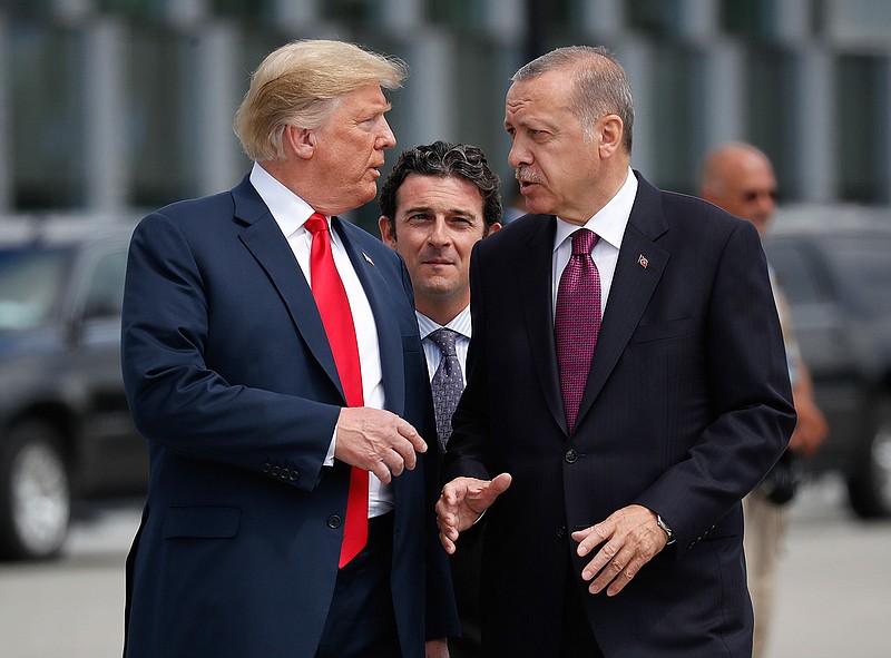  President Donald Trump, left, talks with Turkey's President Recep Tayyip Erdogan on  July 11, 2018, as they arrive together for a family photo at a summit of heads of state and government at NATO headquarters in Brussels. The White House says Turkey will soon invade Northern Syria, casting uncertainty on the fate of the Kurdish fighters allied with the U.S. against in a campaign against the Islamic State group. (AP Photo/Pablo Martinez Monsivais, File)