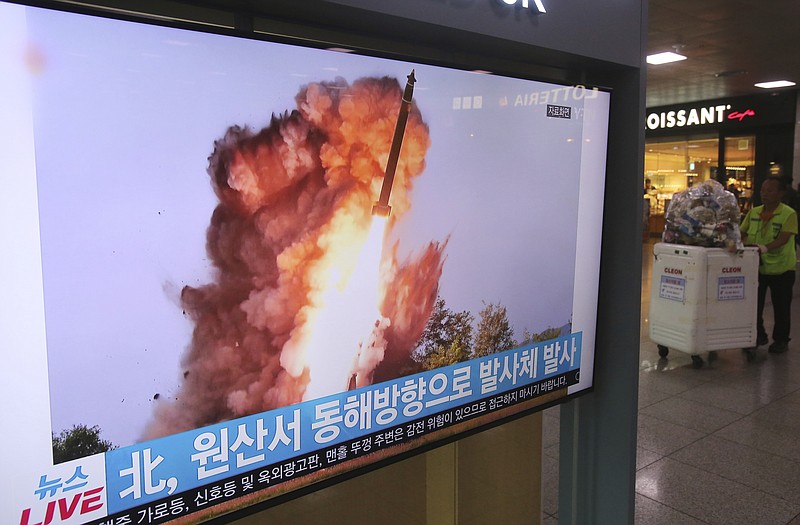 A TV screen shows a file image of a North Korea's missile launch during a news program at the Seoul Railway Station in Seoul, South Korea, Wednesday, Oct. 2, 2019. North Korea on Wednesday fired projectiles toward its eastern sea, South Korea's military said, in an apparent display of its expanding military capabilities ahead of planned nuclear negotiations with the United States this weekend. The sign reads: " A projectile laugh from North Korea." (AP Photo/Ahn Young-joon)