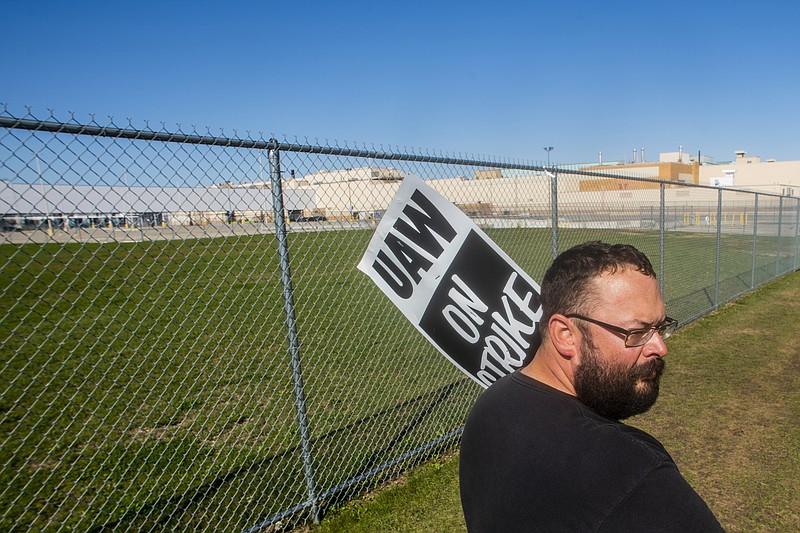 Milford resident Sean Conway, who has 16 years in mostly at General Motors' Flint Assembly Plant, pickets during the nationwide UAW strike against General Motors on Monday, Oct. 7, 2019, in Flint, Mich. (Jake May/The Flint Journal via AP)