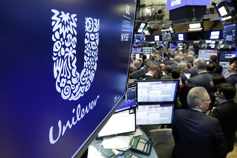 FILE - In this Thursday, March 15, 2018 file photo, the logo for Unilever appears above a trading post on the floor of the New York Stock Exchange. Consumer products giant Unilever, whose brands include Dove soaps and Lipton teas, said on Monday Oct. 7, 2019, they are pledging to halve its use of non-recycled plastics by 2025. (AP Photo/Richard Drew, File)