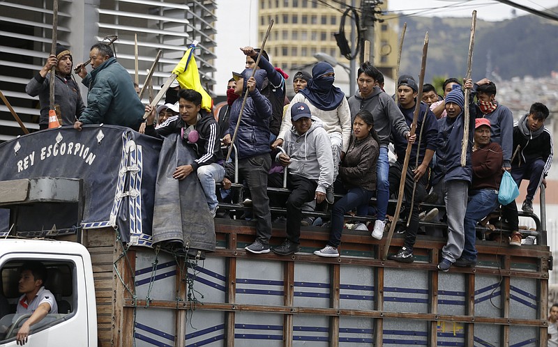 Indigenous anti-government demonstrators arrive to join other indigenous groups to protest against President Lenin Moreno and his economic policies, in Quito, Ecuador, Tuesday, Oct. 8, 2019. Ecuador has endured days of popular upheaval since President Moreno scrapped fuel price subsidies, a step that set off protests and clashes across the South American country.(AP Photo/Fernando Vergara)