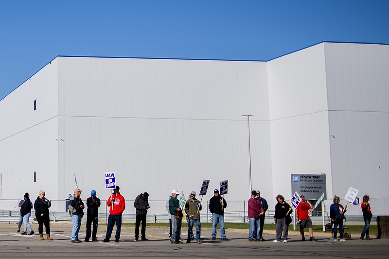 General Motors' Flint Assembly Plant employees line the street with picket signs during the nationwide UAW strike against General Motors on Monday, Oct. 7, 2019, in Flint, Mich. (Jake May/The Flint Journal via AP)